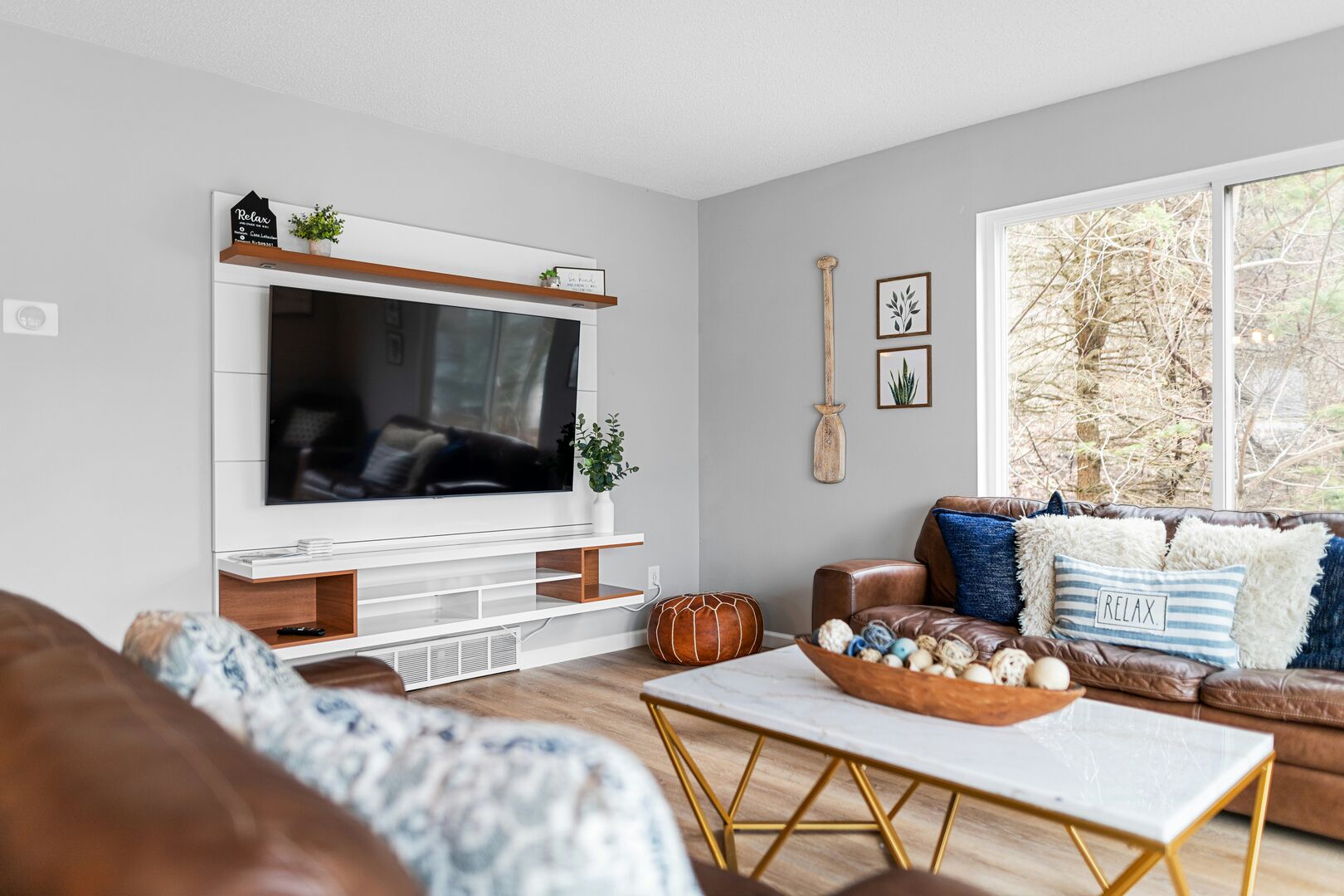 Grey white and brown lake house living room, white shiplap and wood media unit