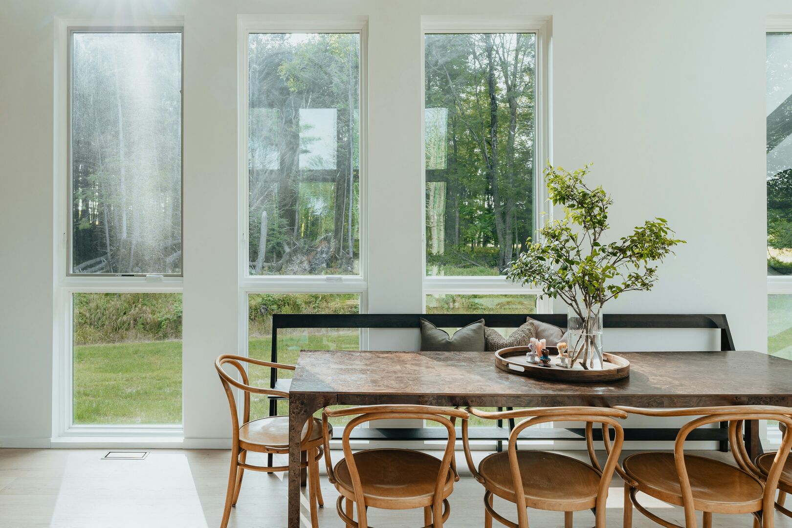 Bright dining room with large floor to ceiling windows