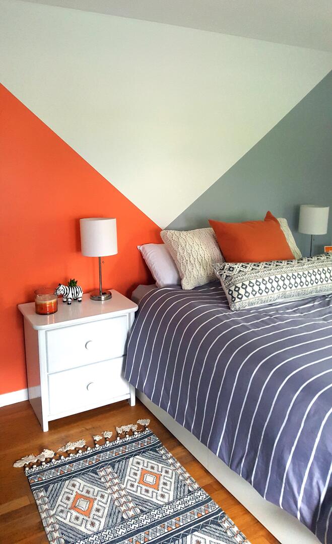 Cozy bedroom with feature wall with colours angles intersecting