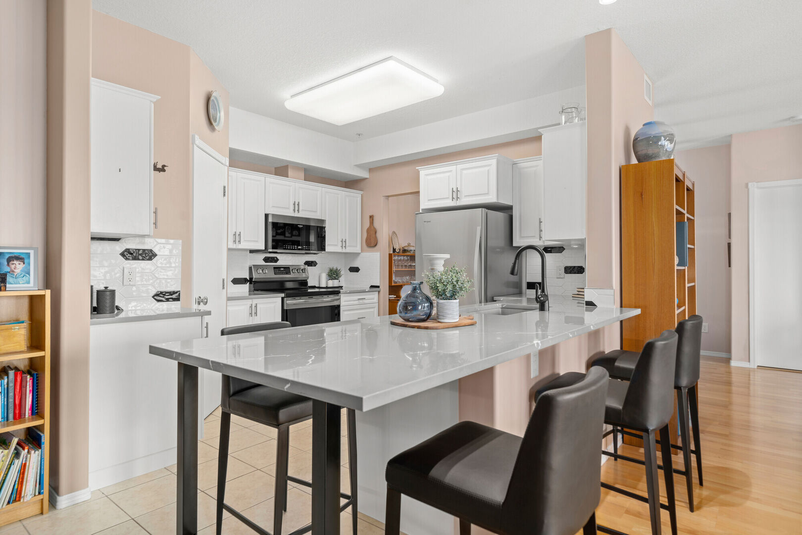 Light and bright white kitchen refresh, Cambria Clare countertops, white kitchen cabinetry and black hardware