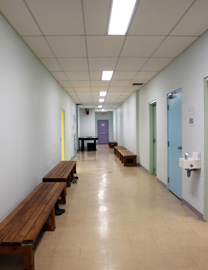 Basement hallway with colour coded doors for wayfinding