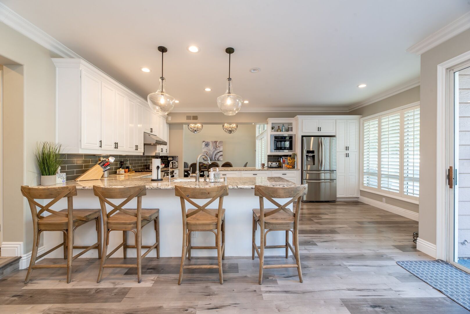 Rustic warm kitchen with wooden stools at peninsula